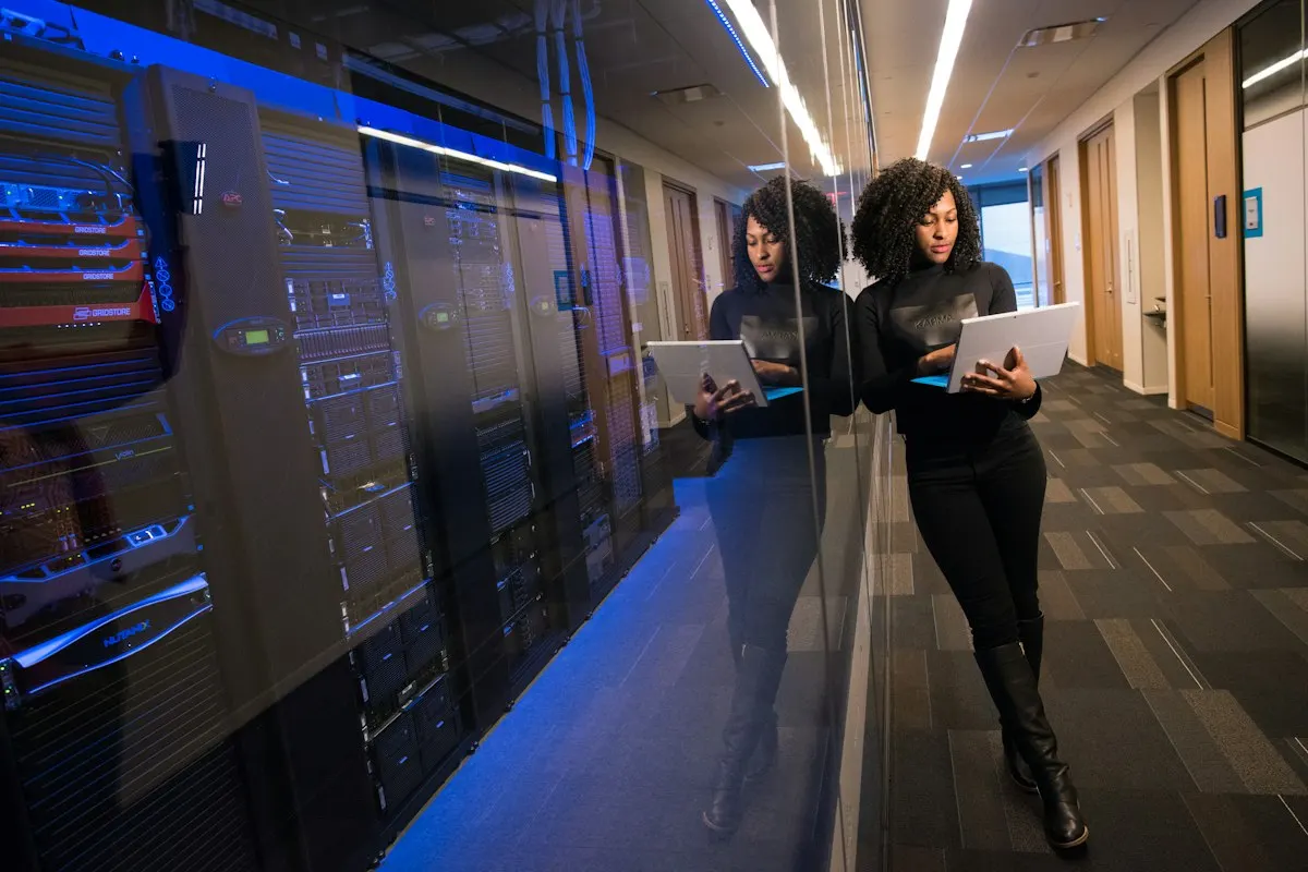Engineers with laptops in a data center